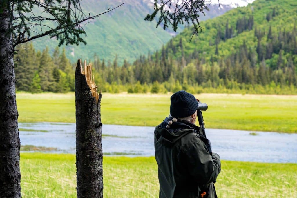 Spotter met verrekijker tijdens Chinitna Bay Bear Viewing