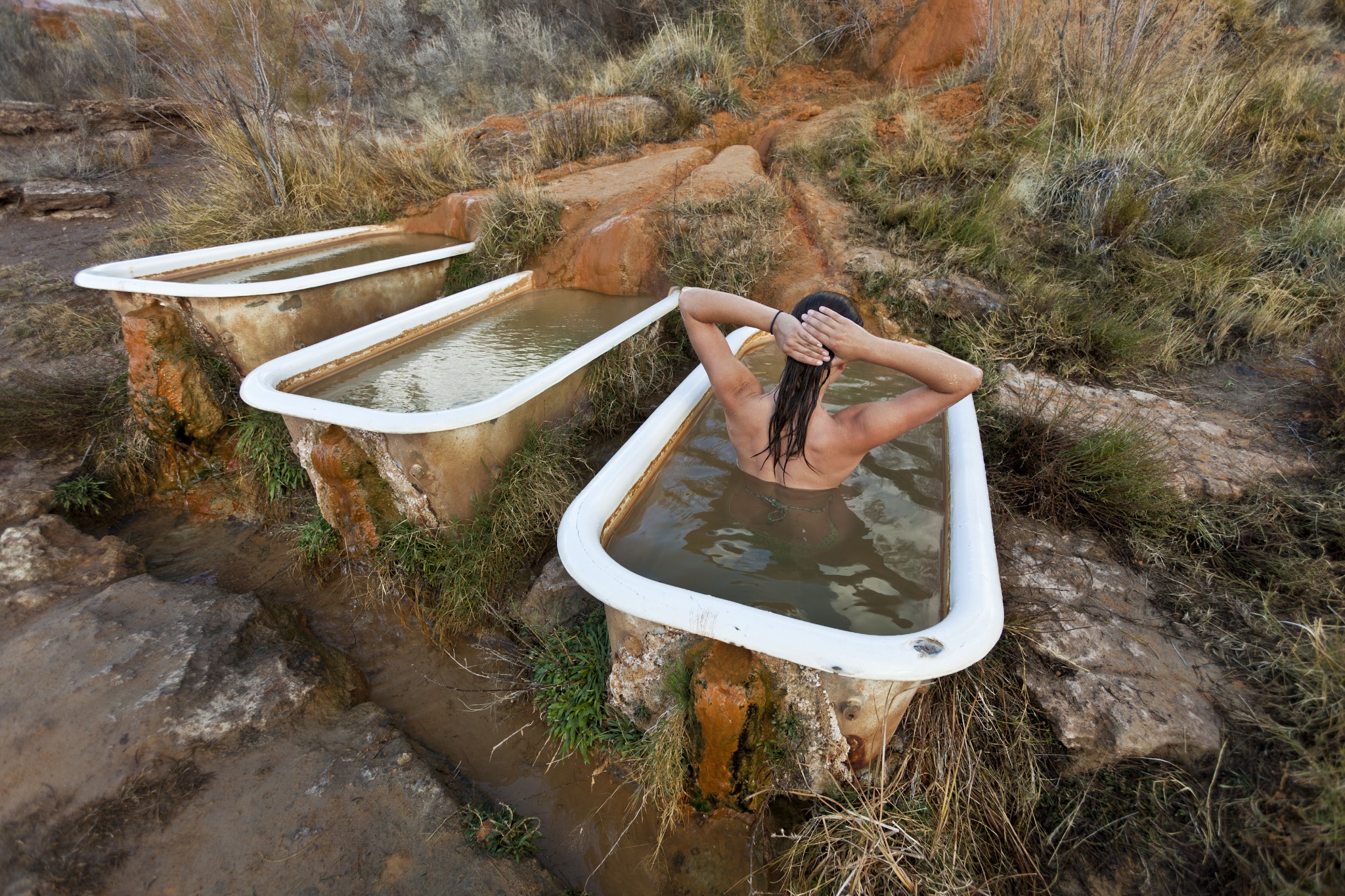 Persoon in warmwaterbad bij Mystic Hot Springs Utah