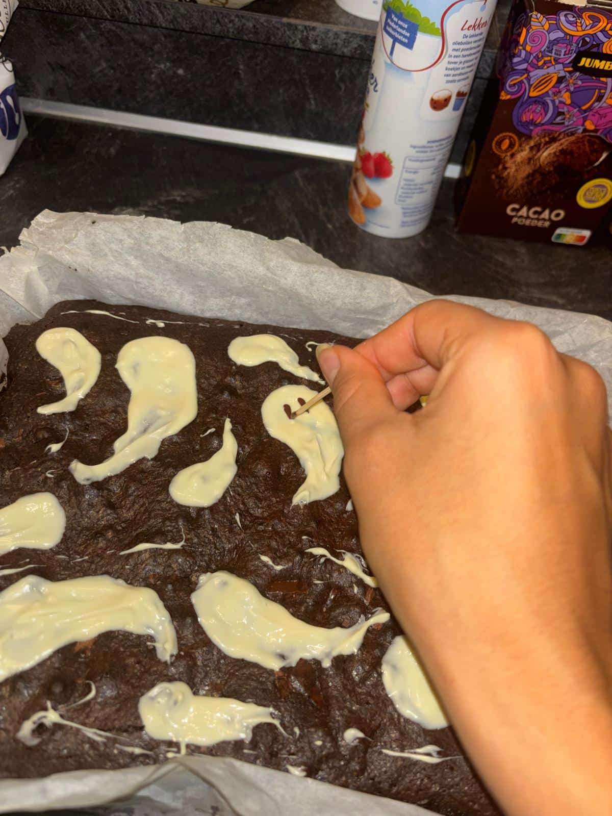 Een gezichtje van pure chocolade wordt met een tandenstoker aangebracht